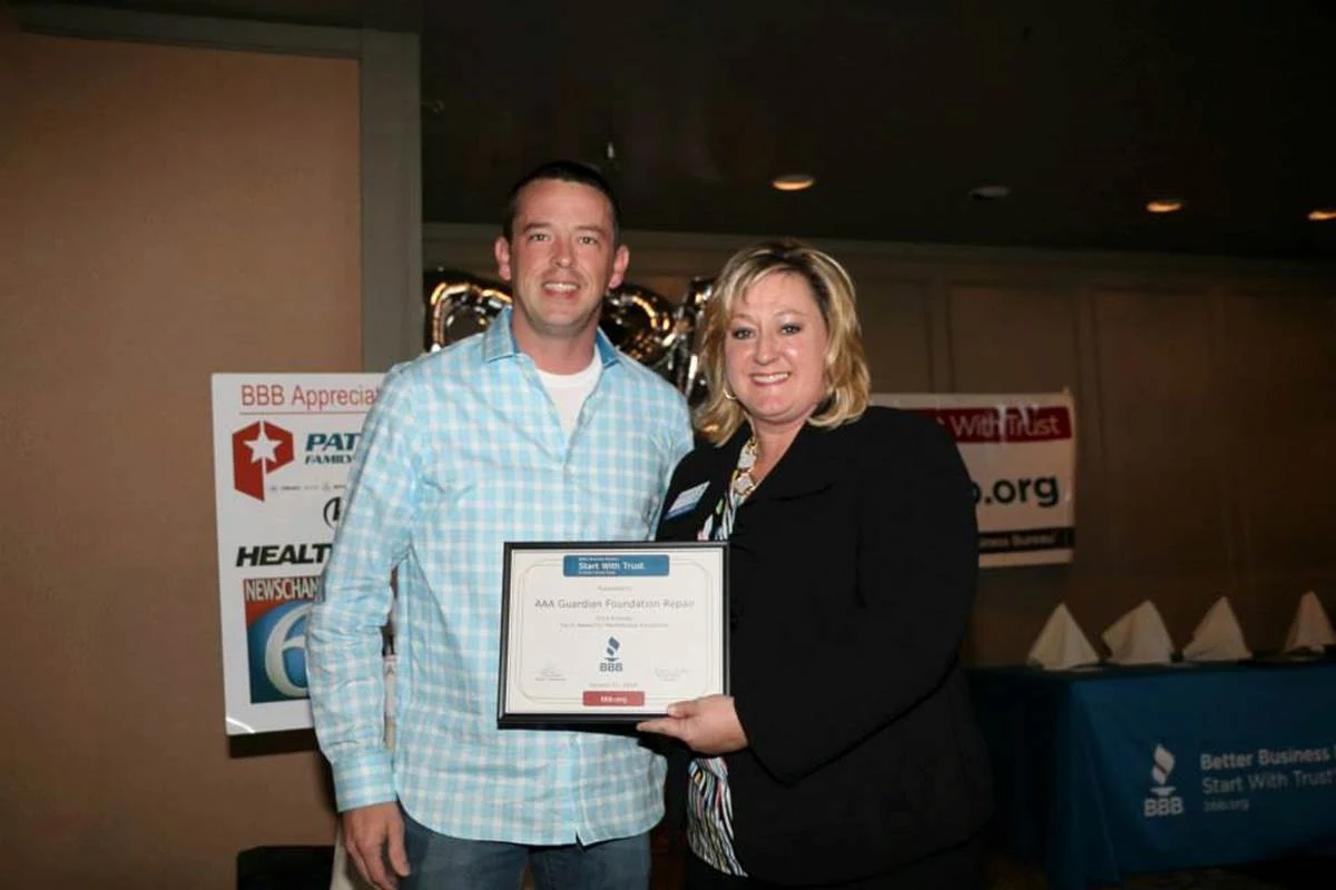 Jared Golden, Managing Partner of AAA Guardian Foundation Repair, receiving the BBB Torch Award for Ethics